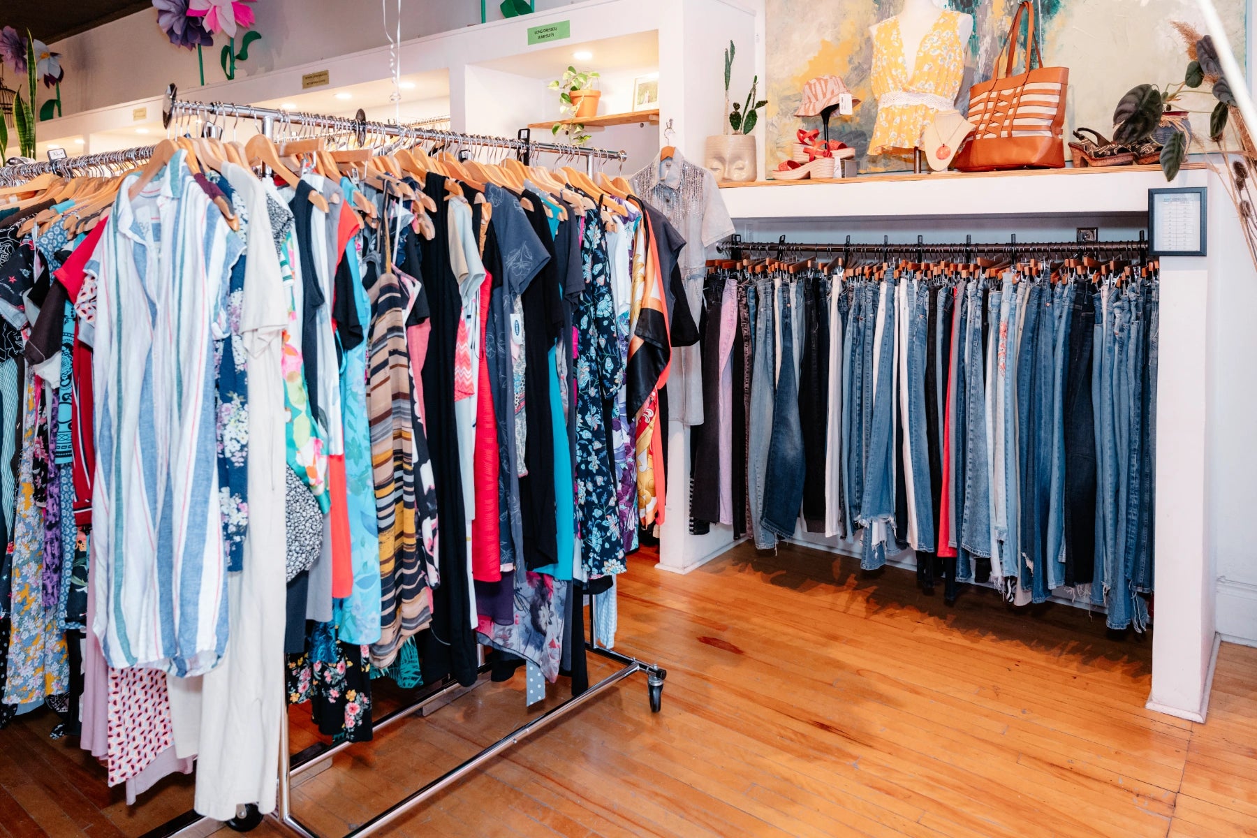 The Reloved Boutique interior with racks of clothes and a display counter.