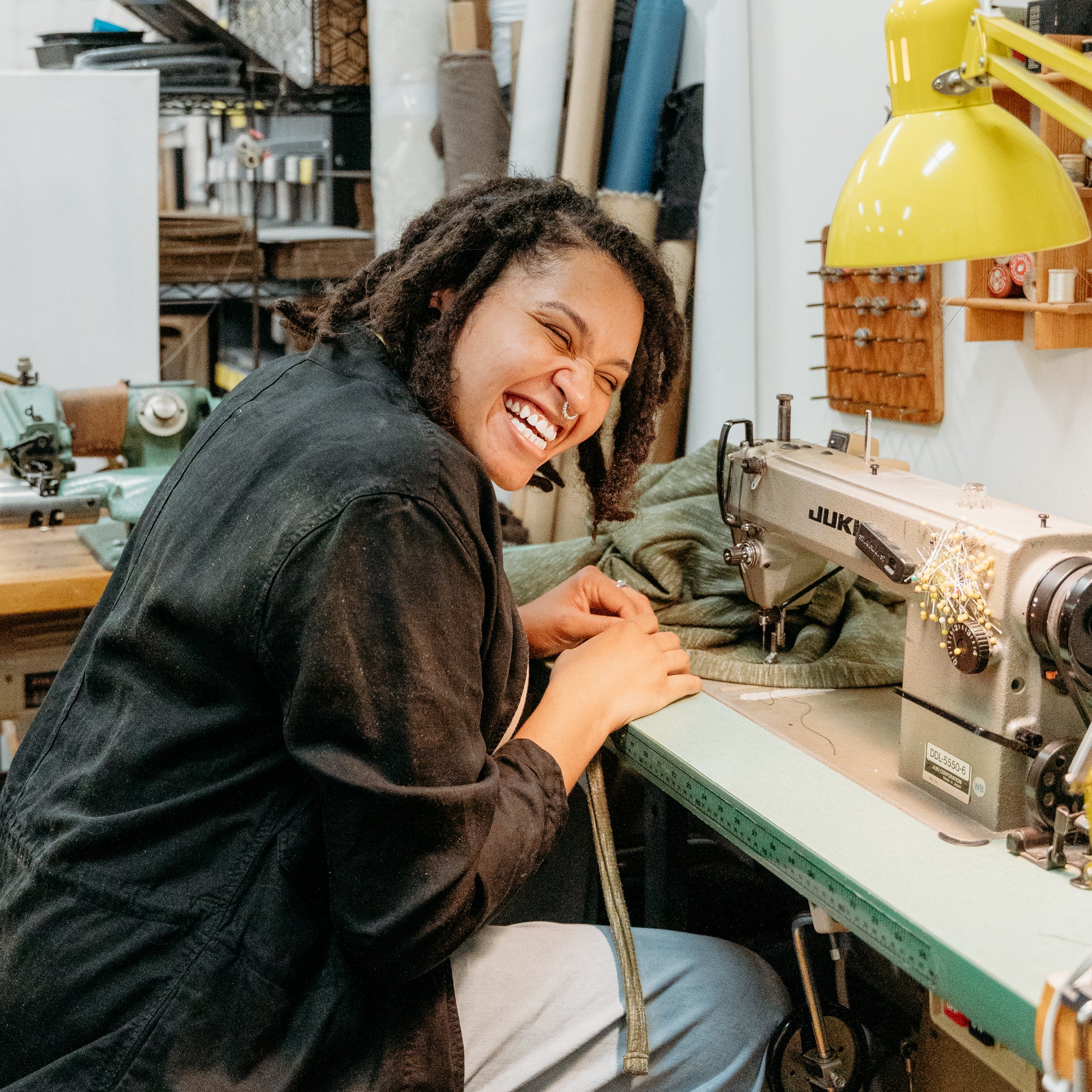 Lex of The Reloved Boutique in Hamilton sat at her sewing table completing an alteration project.